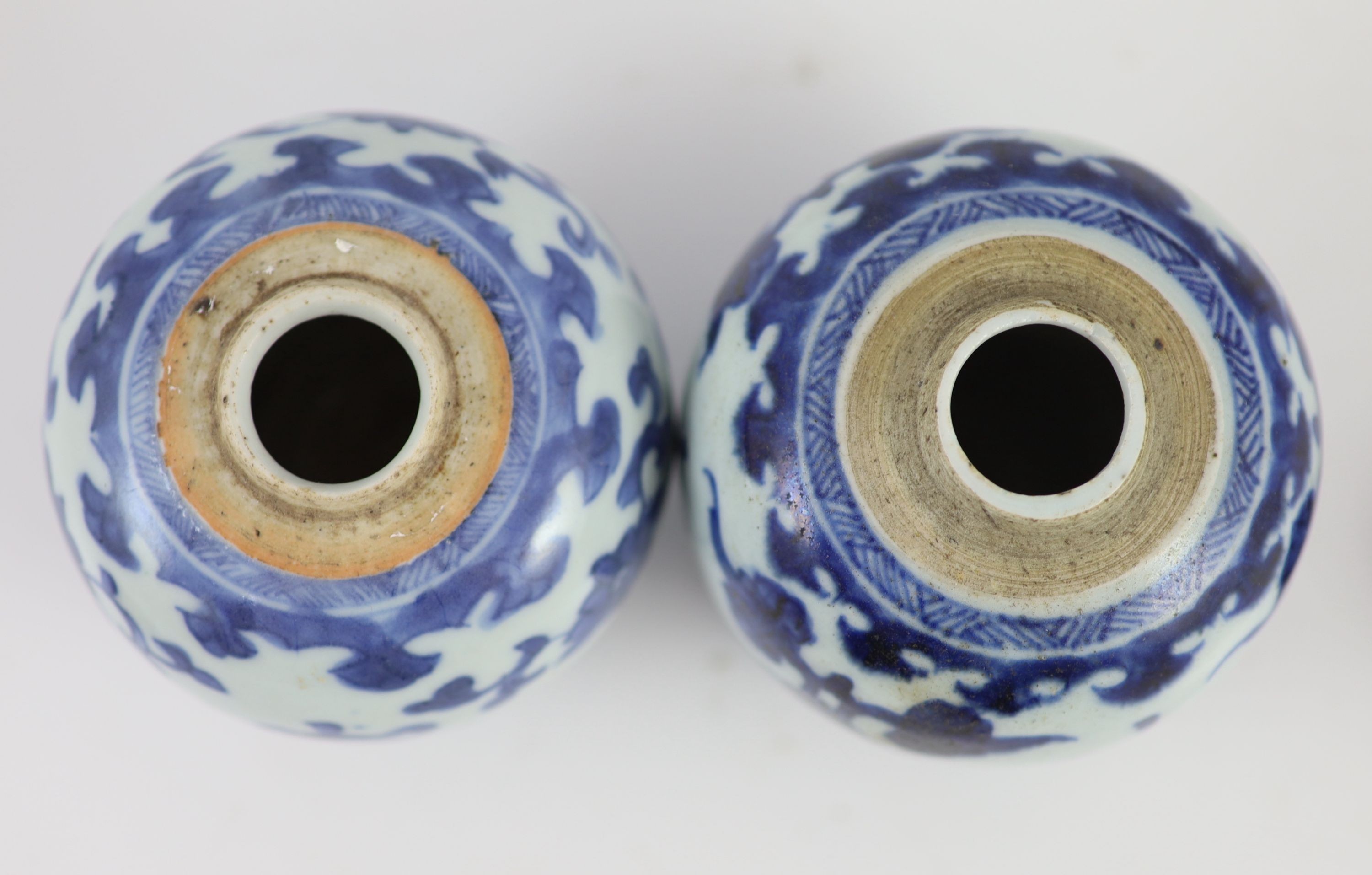 A near pair of Chinese blue and white ovoid jars, Kangxi period, 10 cm high, wood covers